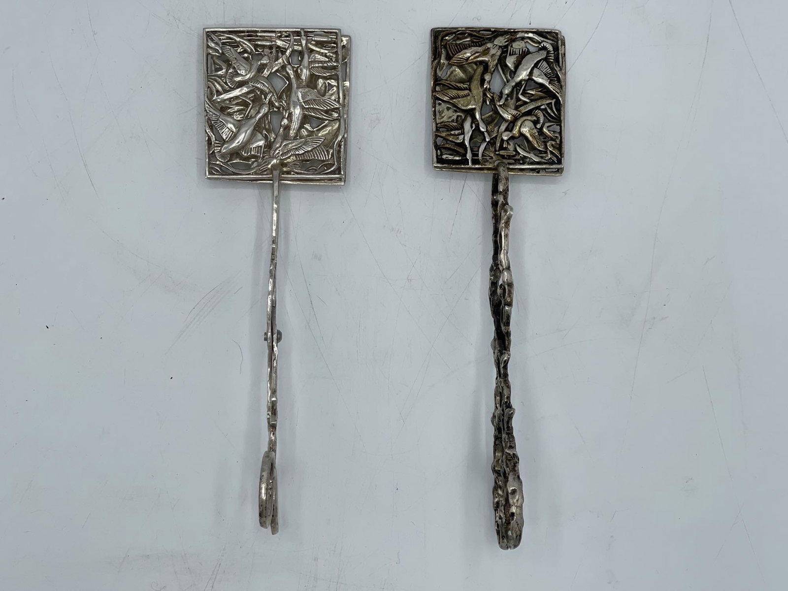 Pair of Sterling Silver Asparagus Tongs: A pair of sterling silver asparagus tongs with bird decoration and ornate handles. RN 23 hallmark, and marked sterling on interior of tongs. 7.65 ozt. 8-1/2in tall x 3in wide. | Local and NYC curbside