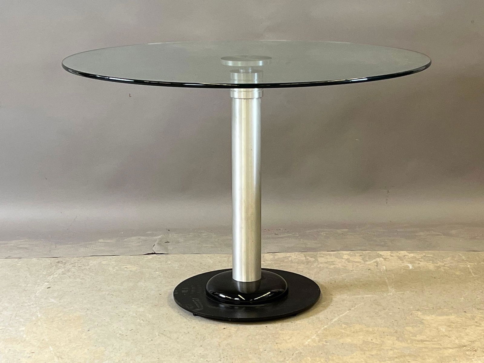 Kaiser Newman Postmodern Dining Table: A Kaiser Newman postmodern glass-top dining table on a machined metal base. 29-1/2in tall x 42in diameter. | Local and NYC curbside delivery details and international third-party shipper recommendatio