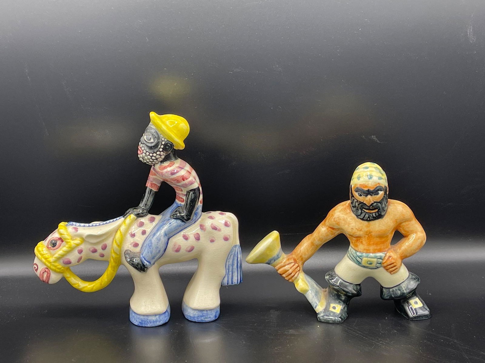 Two Shearwater Ceramic Figurines: Two Shearwater ceramic figurines circa 1930 to include a pirate Blunderbuss figure and a figure riding a horse. Unmarked. Larger: 8-1/2in tall. Provenance: Chestnut Hill Arts & Crafts private collecti