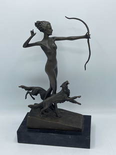 Josef Lorenzl. Bronze, Diana: Josef Lorenzel (1892-1950). A bronze of Diana the Huntress holding a bow with two dogs by her side, resting on marble base. Signed Lorenzl en verso. 12in tall x 7-1/2in wide. | Local and NYC curbside