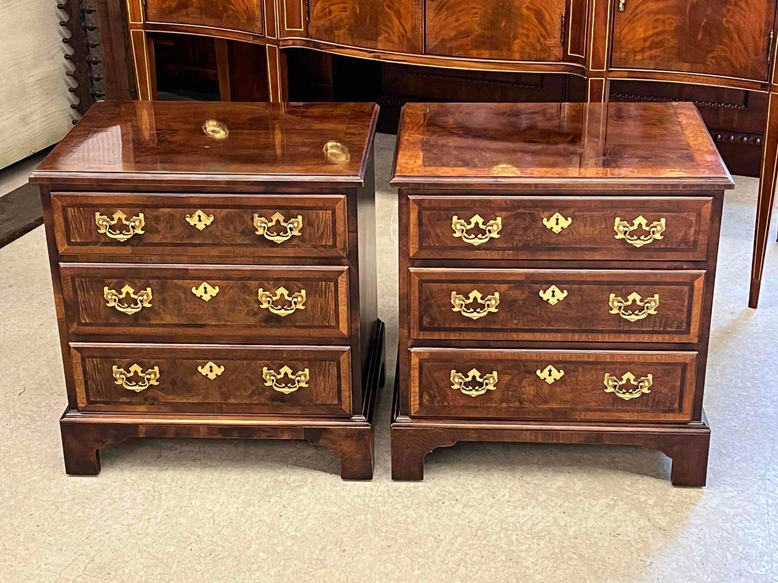 Pair of Henredon Aston Court Mahogany Nightstands: A pair of Henredon Aston Court Chippendale-style mahogany three-drawer nightstands. Each: 24in tall x 23in wide x 17in deep. | Local and NYC curbside delivery details and international third-party shi