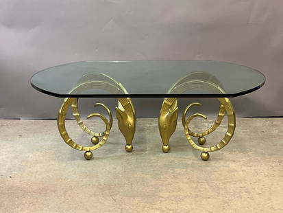 Alain Chervet-style Ibex Cocktail Table: An Alain Chervet-style cocktail table with a glass top over a gilt metal ibex head design base. 18-1/2in tall x 52in wide x 40in deep. | Local and NYC curbside delivery details and international third