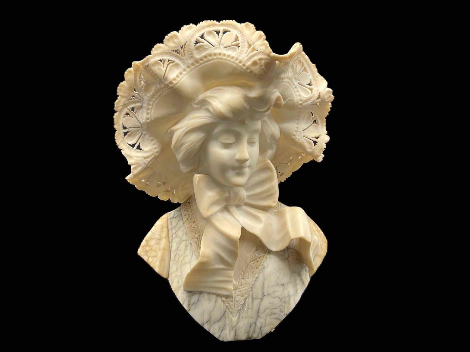 A. Cipriani Italian Alabaster Bust: Aldolfo Cipriani (Italian, 1880-1930). A carved Italian alabaster bust of a woman in an ornate lace hat with large tied bow. Signed A. Cipriani on back. 18in tall x 10-1/2in wide. Provenance: From a P