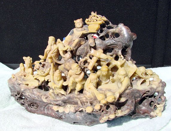 Chinese Carved Soapstone Daoist Grouping: Chinese soapstone carving of the Eight Daoist Immortals. 6" tall; 11.25" wide.
