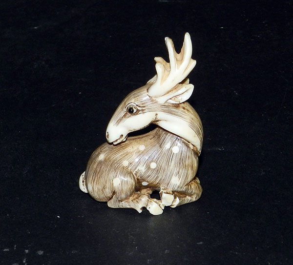 Antique Ivory Netsuke: Sitting Antelope: Signed antique ivory netsuke sitting antelope. 1-1/3" long; 2-1/4" high; 1" wide.