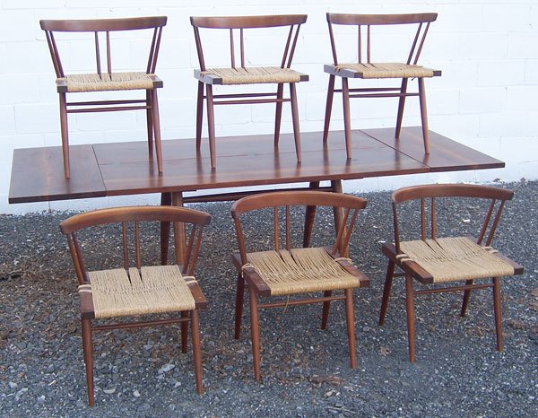 6 George Nakashima Chairs: Set of 6 George Nakashima walnut dining room chairs with woven grass seats. Height: 27-1/2" tall to top of back; 23" wide.