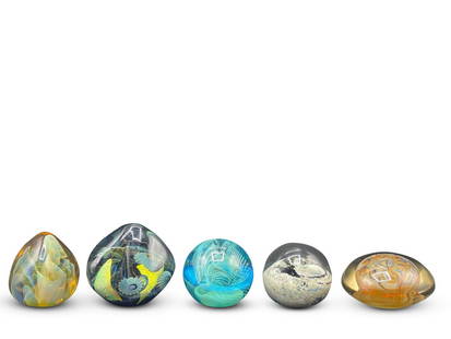 Five Signed Art Glass Paperweights: To include a Robert William Bartlett signed abstract; a signed Gilbert John; a Slade '83 turquoise paperweight; a Robert Eichholt 2006 paperweight; and a signed Kolmar Tora. Largest: 4in tall x 4in wi