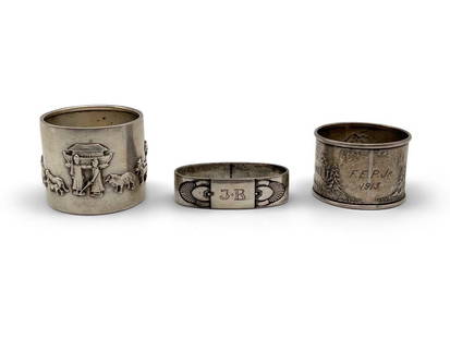 Three Sterling Silver Napkin Rings: A grouping of three sterling silver napkin rings to include a Gorham Noah and the Ark, a Georg Jensen, and a Simons brothers sterling with Hey Diddle Diddle nursery rhyme motifs. Noah and the Ark: 1-1