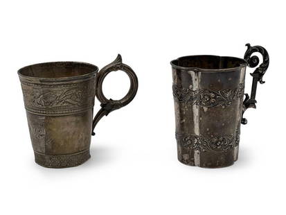 Two Victorian Sterling Handled Mugs: Two Victorian sterling silver handled mugs to include a Gorham mug with ring handle and classical design in relief, and a George W. Shiebler mug with raised foliate and scroll design. Taller: 4-1/4in