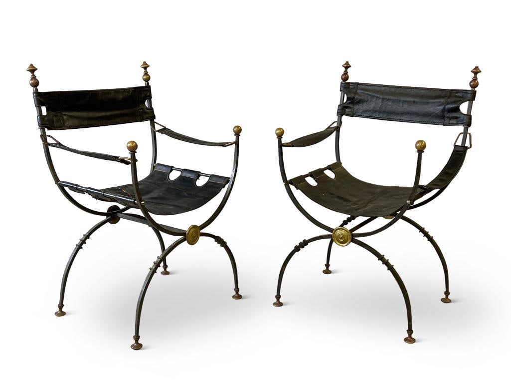 Pair of Wrought Iron and Brass Curule Chairs: A pair of Continental wrought iron Curule or Savonarola chairs with brass accents and leather sling seats and backs. 33in tall x 20in wide x 16-1/4in deep. | Philadelphia Metro area delivery, NYC curb