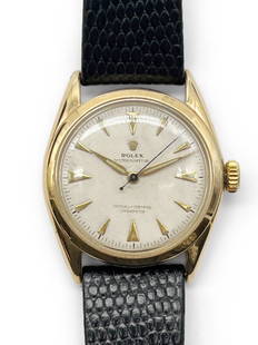 Rolex Oyster Perpetual 14K Gold Wristwatch: A Rolex Oyster Perpetual 14K yellow gold wristwatch, model 6084, circa 1950s, with a 34mm case excluding Super Oyster Rolex crown, with a white dial and dart indexes. Self-winding movement marked