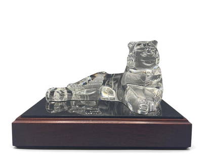 Steuben Noble Tiger Figure: A Steuben glass tiger sculpture resting on wooden base. Tiger: 4-1/2in tall x 7-1/2in wide. | Philadelphia Metro area delivery, NYC curbside delivery, and international third-party shipper information