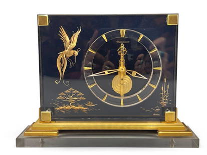 Jaeger Le Coultre Marina Desk Clock: A Jaeger Le Coultre Marina chinoiserie desk clock on brass base, mounted on lucite base. 7in tall x 9-1/2in wide. | Philadelphia Metro area delivery, NYC curbside delivery, and international