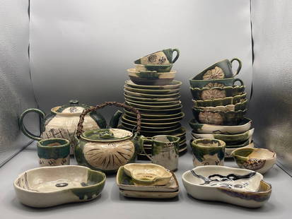 Japanese Oribe Pottery Grouping: A 41-piece grouping of hand painted Japanese ceramic pottery to include teapots, saucers, tea cups, and plates. Inscribed with signature on bottom. Teapot: 5-1/2in tall x 6in wide. Provenance: Exhibit