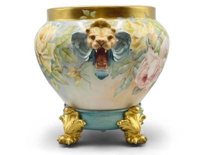 R. Delinieres Co. Limoges Jardiniere: A hand-painted two-piece Limoges porcelain jardiniere resting on a gilt-decorated paw-foot base with rose motifs and lion handles. R & C stamp on base. 12in tall x 15in wide. | Philadelphia Metro area