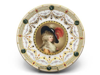 Royal Vienna Duchess of Devonshire Plate: A Royal Vienna porcelain portrait plate depicting the Duchess of Devonshire wearing a feathered hat with gilt decorated flowers and marbleized green cabochons surrounding. Signed Wagner under portrait