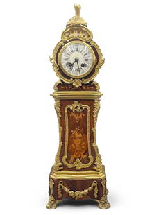 19th C. French Miniature Grandfather Clock: A 19th Century French miniature grandfather clock with porcelain face surrounded by gilt bronze foliate swag and an inlaid marquetry wood body. 20-1/2in tall x 6-1/2in wide. | Philadelphia Metro area