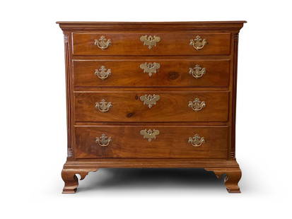 Chippendale Walnut Four-Drawer Chest: A Chippendale walnut four-drawer chest with an overhanging top over a graduated four-drawer arrangement flanked by reeded quarter columns. Raised on ogee bracket feet. 34in tall x 36in wide x 18-1/2in