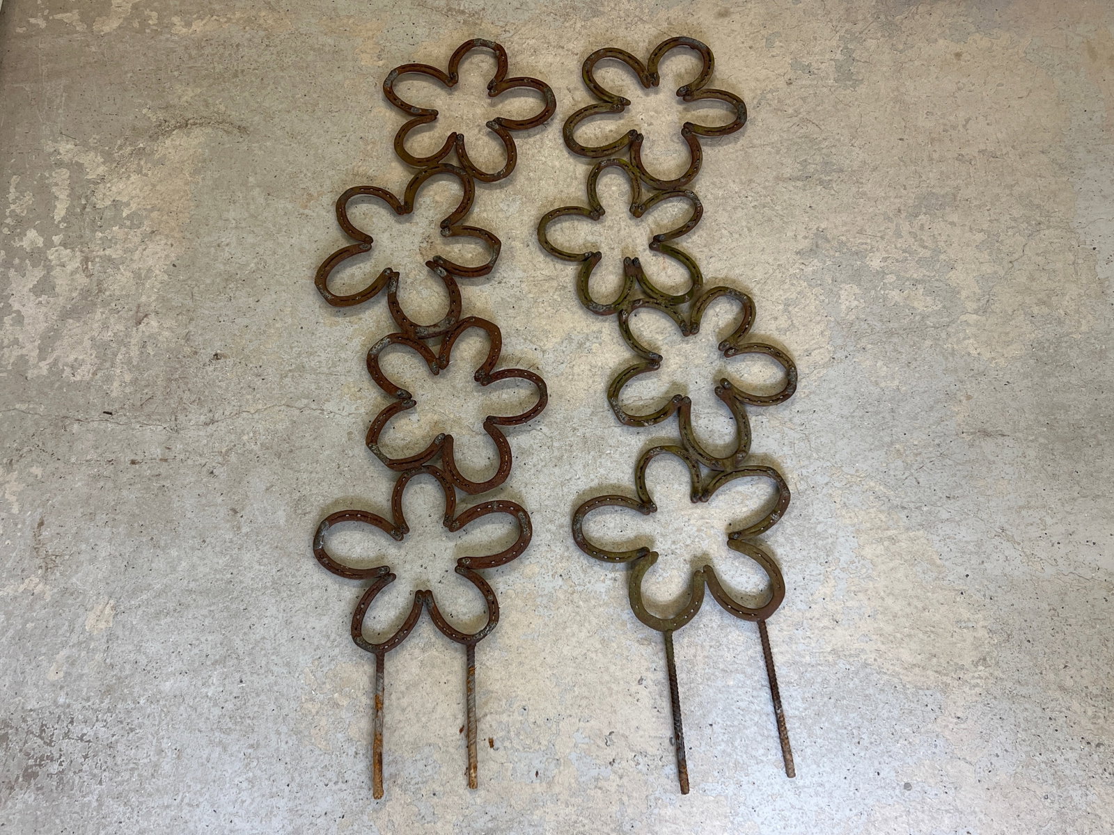 Pair of Horseshoe Sculptural Garden Ornaments: A pair of welded horseshoes garden trellis ornaments in the form of open flowers. Each is 61in tall x 19in wide. | Philadelphia Metro area delivery, NYC curbside delivery, and international third-part