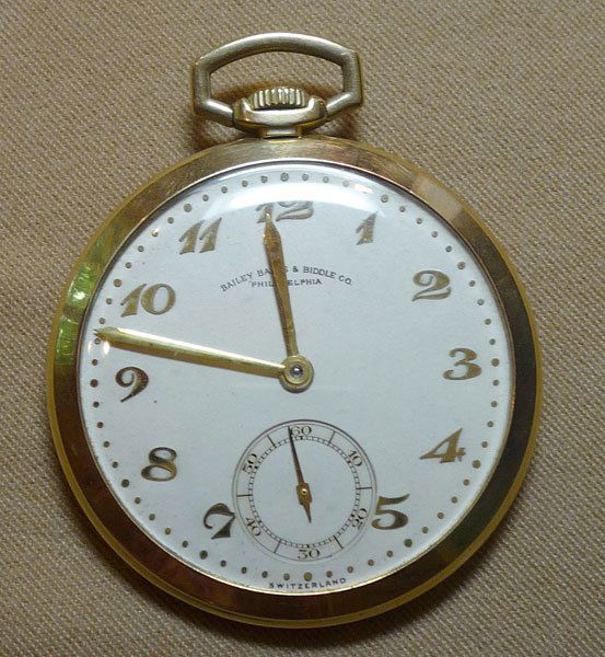 Movado Gold Pocket Watch: Movado gold pocket watch with 14K yg (marked) open face thin case and white face with gold numbers. Marked Bailey Banks & Biddle Co. Size 17; 17 jewels, 24.5dwt.