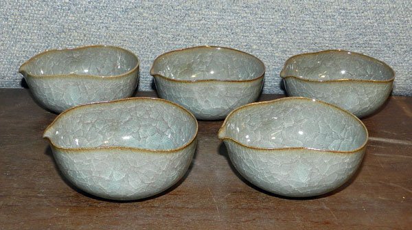 Five Japanese Porcelain Mukozuke Cups: Set of 5 Japanese porcelain Mukozuke gourd-shaped cups with celadon and large crackle glaze. Each signed on base. 1-1/2 tall; 3-3/4" long; 3-1/4" wide. 20th C. With original wooden box.