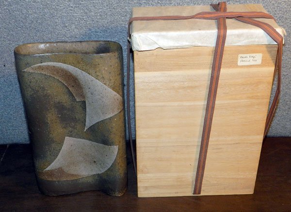 Okada Kenzo Art Pottery Vase: Okada Kenzo, Japanese modern art pottery vase. Tall/narrow form with rounded sides. Paper label on base. 12" tall; 6-7/8" long; 2-3/4" wide. With original wooden box.