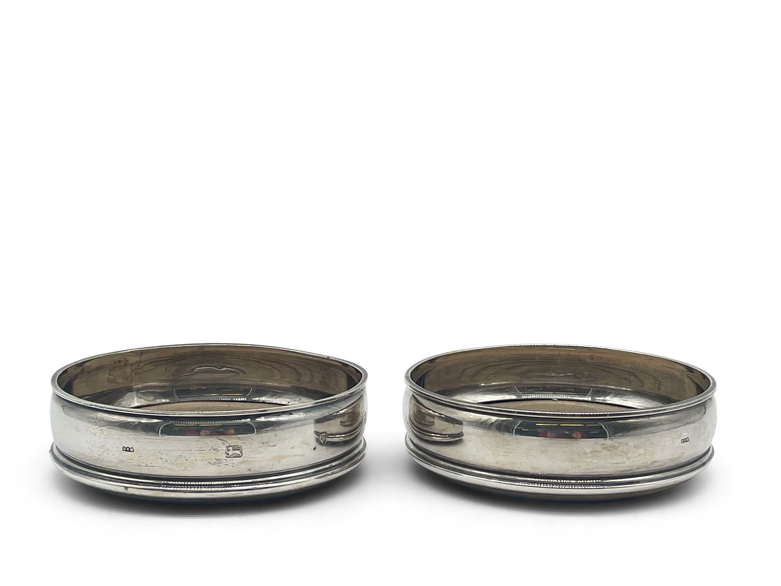 Pair of London Sterling Wine Coasters: A pair of London sterling wine coasters with wooden inserts. Hallmarked on sides. 1-1/2in tall x 5in wide. 7.01 ozt total, including wooden inset. | Philadelphia Metro area delivery, NYC curbside deli