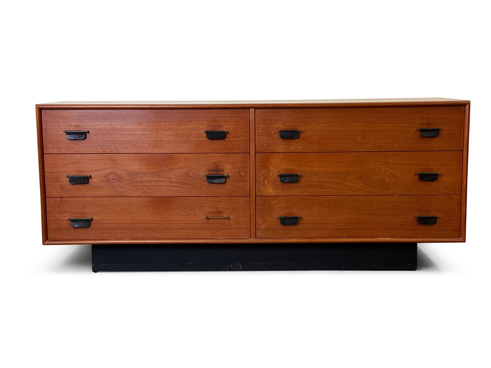 Inter-Continental Teak Dresser: An Inter-Continental teak six drawer low dresser with leather pulls and an ebonized plinth base. 26in tall x 63in wide x 18-1/2in deep. | Philadelphia Metro area delivery, NYC curbside delivery, and i