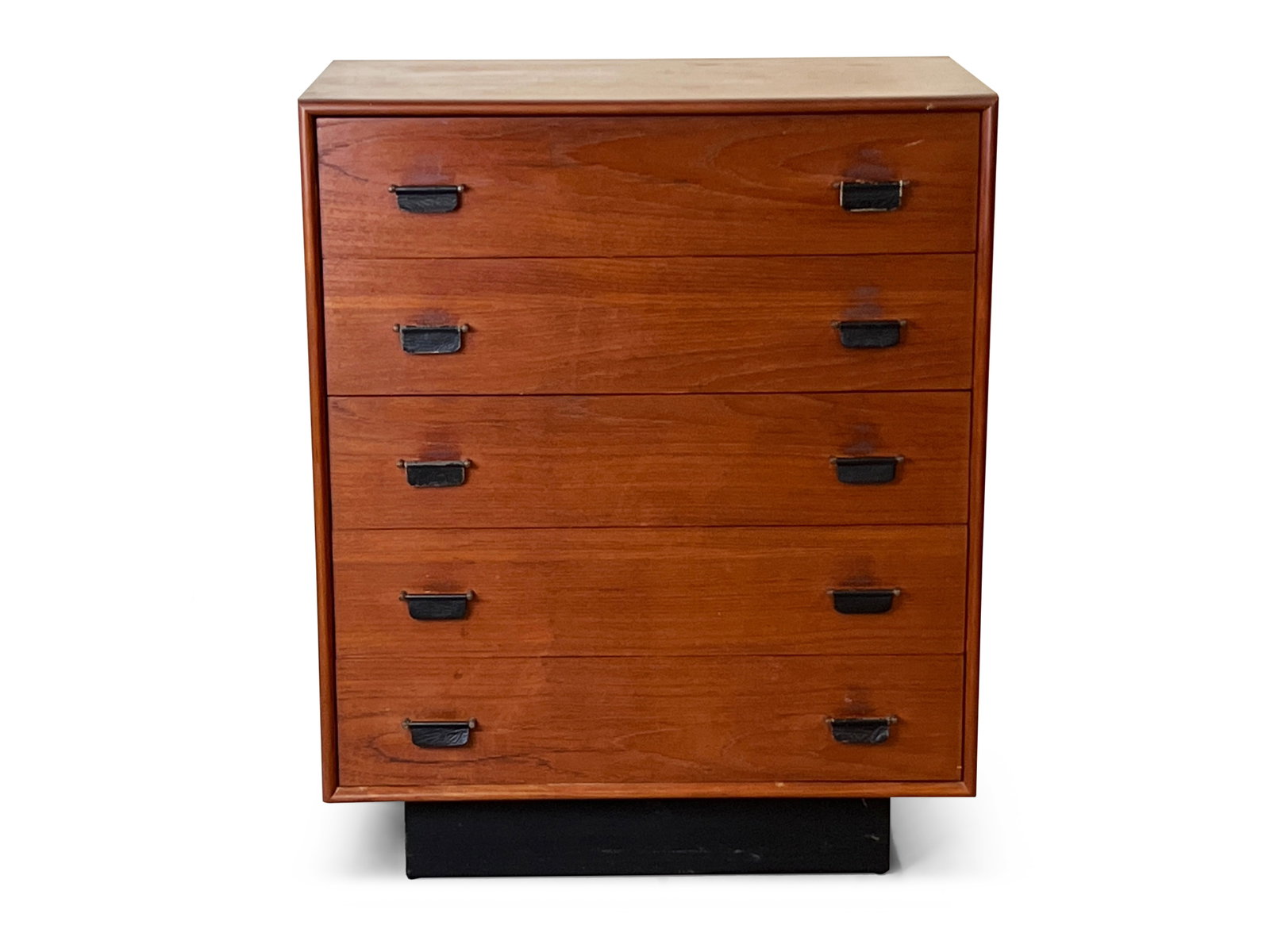 Inter-Continental Teak Chest of Drawers: An Inter-Continental teak chest of five drawers with leather pulls and an ebonized plinth base. 39in tall x 32in wide x 18-1/2 in. | Philadelphia Metro area delivery, NYC curbside delivery, and intern