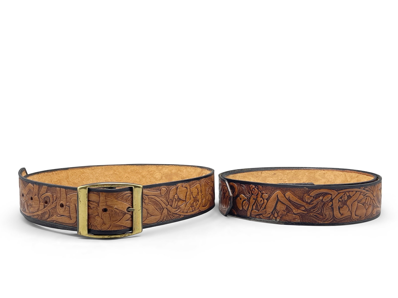 Two 1970s Erotic Tooled Leather Belts: Two 1970s tooled leather belts with erotica motif throughout. Larger: 45-1/2in long. | Philadelphia Metro area delivery, NYC curbside delivery, and international third-party shipper information are al