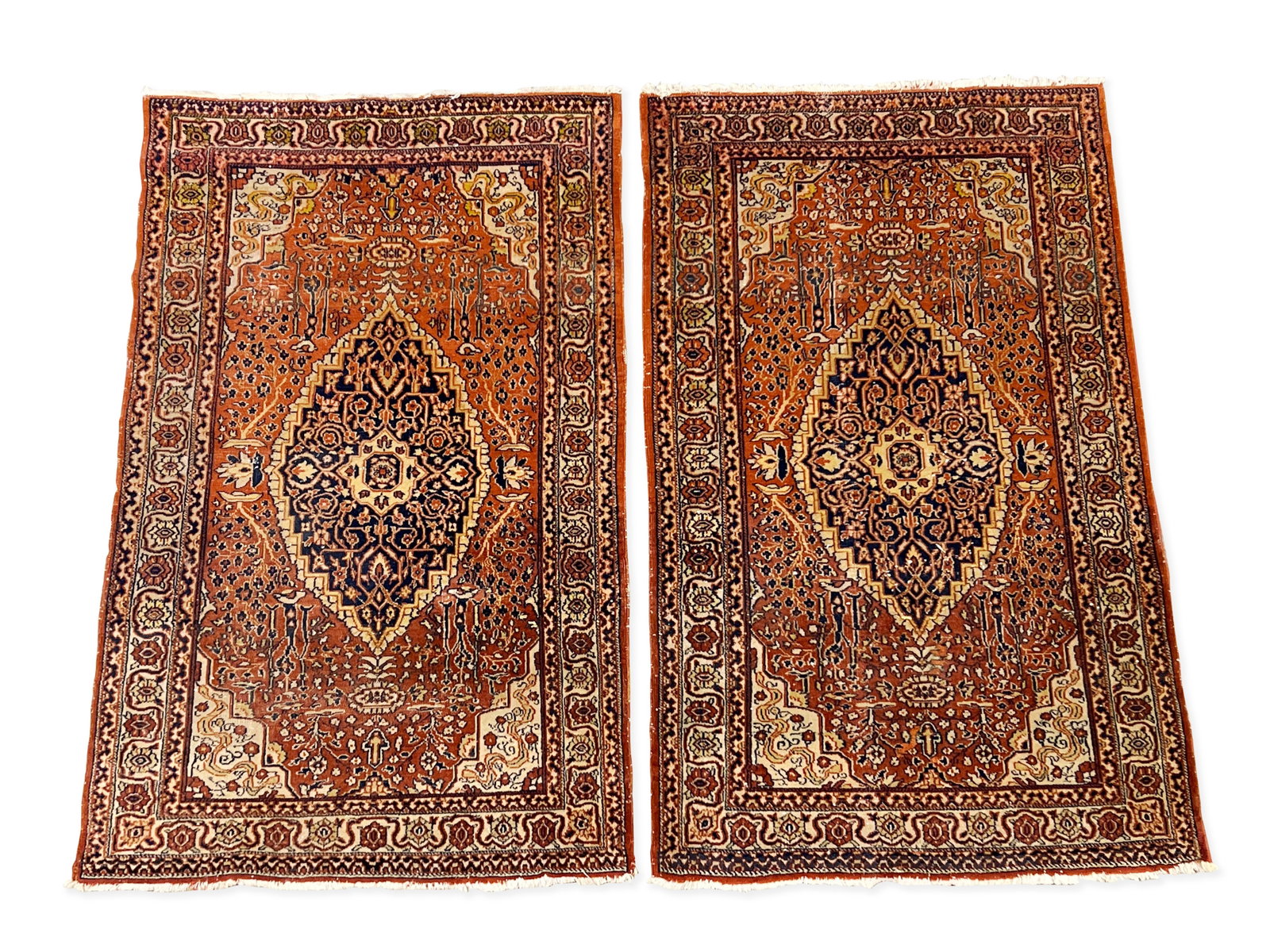 Pair of Persian Kashmir Mats: A pair of Persian Kashmir mats with dark blue medallions and rust fields. 4ft 11in x 3ft 1in. | Philadelphia Metro area delivery, NYC curbside delivery, and international third-party shipper informati