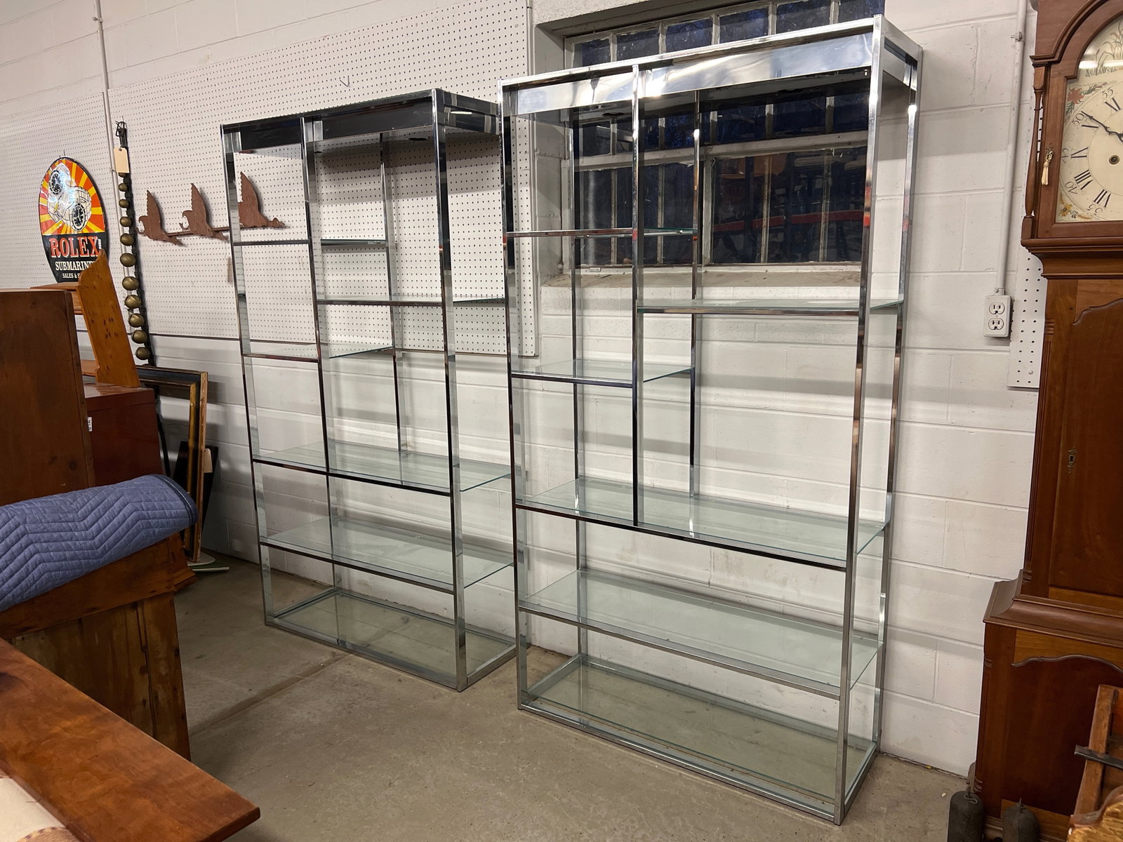 Pair of Chrome and Glass Modernist Etageres: A pair of chrome frame étagères with glass shelves and illuminated tops. 78in tall x 42in wide x 16in deep. | Philadelphia Metro area delivery, NYC curbside delivery, and international t