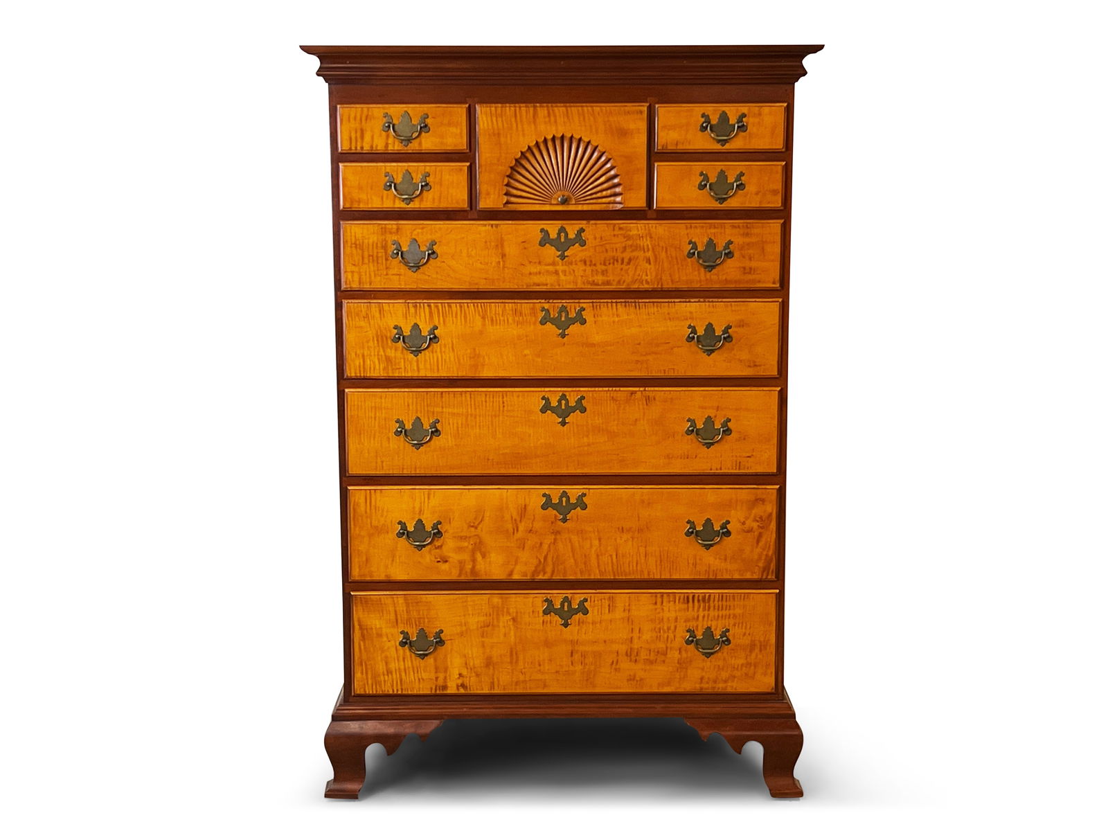 Eldred Wheeler Cherry and Maple Tall Chest: An Eldred Wheeler cabinet-made Chippendale-style cherry semi-tall chest of drawers with tiger maple drawer fronts, the central most shell carved, raised on ogee bracket feet. 56in tall x 37in wide x 1