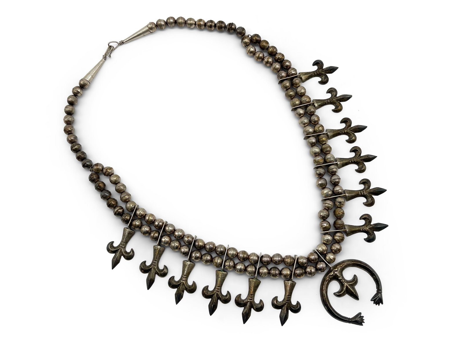 Navajo Silver Squash Blossom Necklace: A Navajo silver squash blossom necklace. Unmarked. Naja: 1-1/2in x 1-3/4in. 25in long. 104.2 dwt. | Philadelphia Metro area delivery, NYC curbside delivery, and international third-party shipper infor