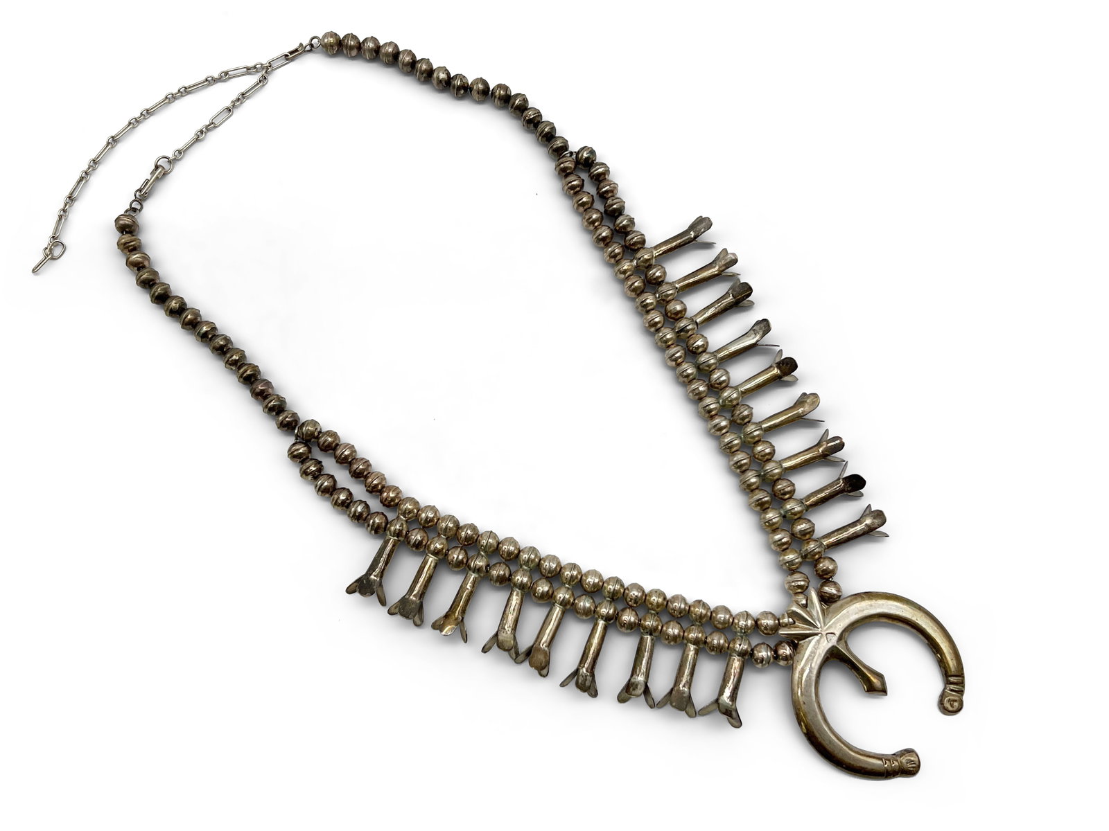 Navajo Silver Squash Blossom Necklace: A Navajo silver squash blossom necklace. Unmarked. Naja: 2-5/8in x 2-3/8in. Necklace: 24in long; with extender: 33in long. 88.67 dwt. | Philadelphia Metro area delivery, NYC curbside delivery, and int
