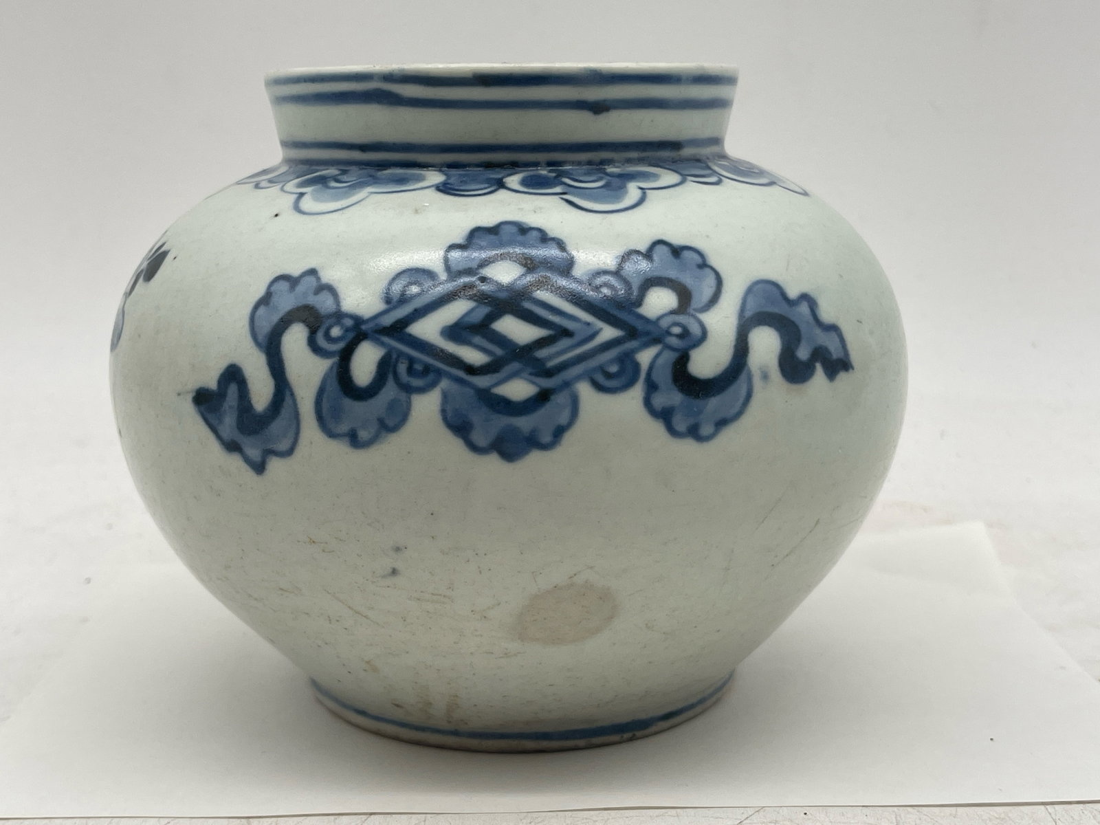 Korean Blue and White Jar: A Korean blue and white jar with stylized flowers and concentric rings around rim. 5-1/2in tall x 5-1/2in wide. | Philadelphia Metro area delivery, NYC curbside delivery, and international third-party