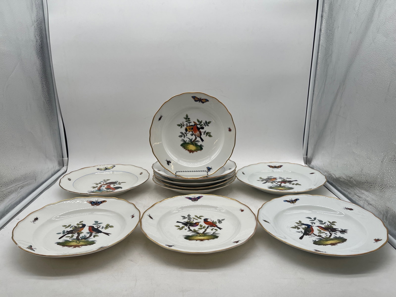 Ten Meissen Rothschild Bird Porcelain Bowls: A set of ten Meissen porcelain hand-painted bowls with bird and insect motif and gilt-painted scalloped edges. Meissen mark on bottom. 9-1/2in diameter. | Philadelphia Metro area delivery, NYC curbsid