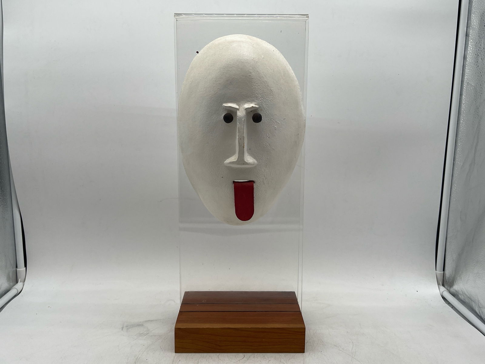David Gil Ceramic Head Sculpture: A David Gil ceramic head sculpture with leather tongue, mounted on a lucite and wood base, and impressed with "DG" and "Bennington Potters Vermont". 19in tall x 7-1/2in wide. | Philadelphia Metro area