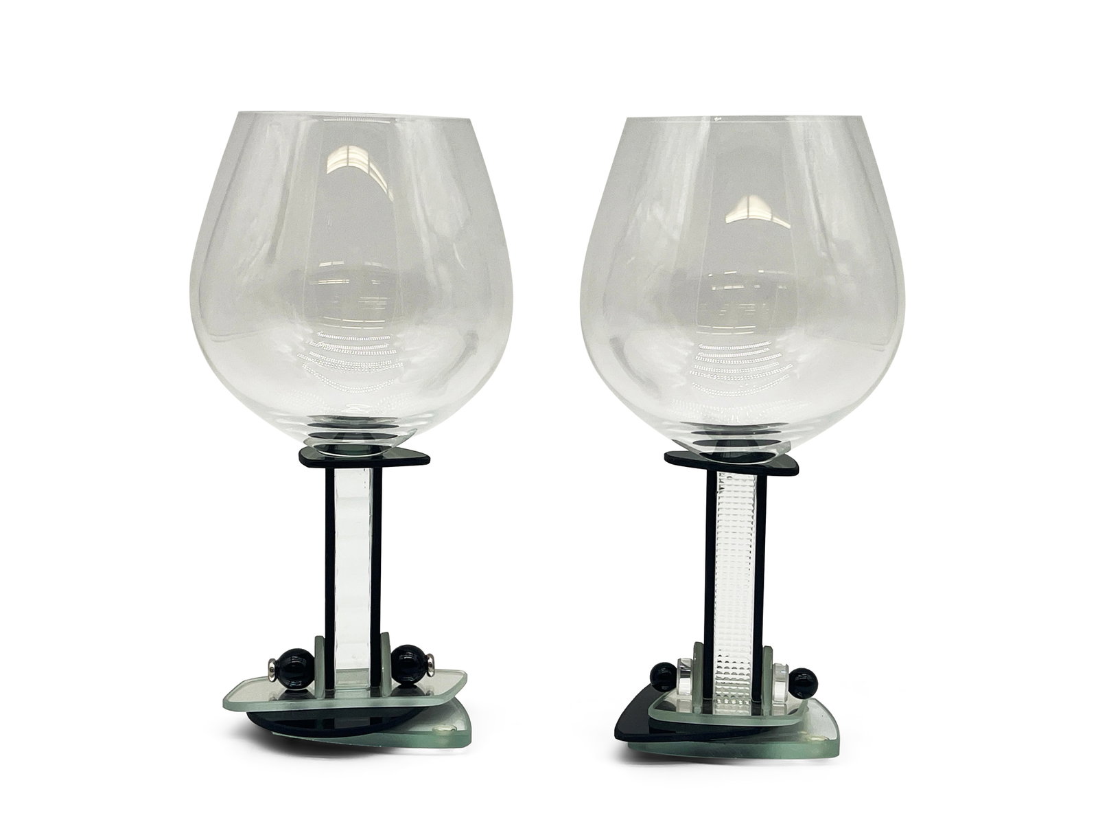 Two George Ponzini Memphis Wine Glasses: A pair of George Ponzini Memphis-style architectural wine glasses. Marked on underside. 8in tall x 3-1/2in wide. | Philadelphia Metro area delivery, NYC curbside delivery, and international third-part