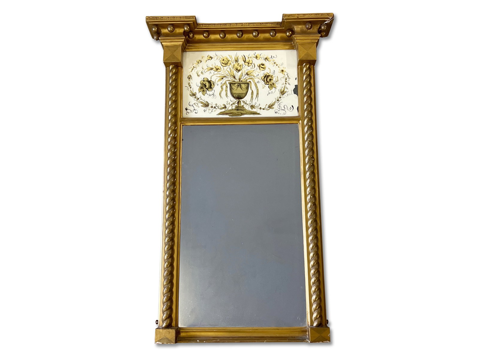 Regency Giltwood and Eglomise Wall Mirror: A Regency giltwood wall mirror having an eglomise upper panel with floral urn vase. 41in tall x 24-1/2in wide. | Philadelphia Metro area delivery, NYC curbside delivery, and international third-party 