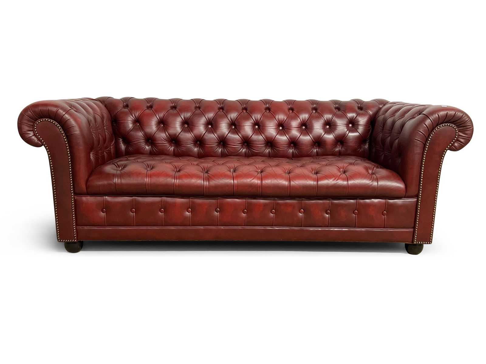 Burgundy Leather Chesterfield Sofa: A Burgundy leather chesterfield sofa. 26in tall x 73in wide. | Philadelphia Metro area delivery, NYC curbside delivery, and international third-party shipper information are all available on our websi