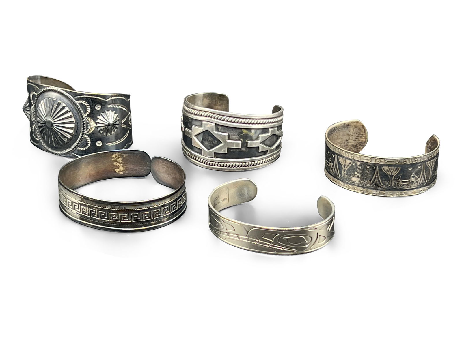 Five Cuff Bracelets: A grouping of five cuff bracelets to include a Gerard & Co. sterling bracelet, a Daniel Yunkws Orca bracelet, and three unsigned. Inside circumferences measure approx. 7in - 8-1/2in. | Philadelphia Me