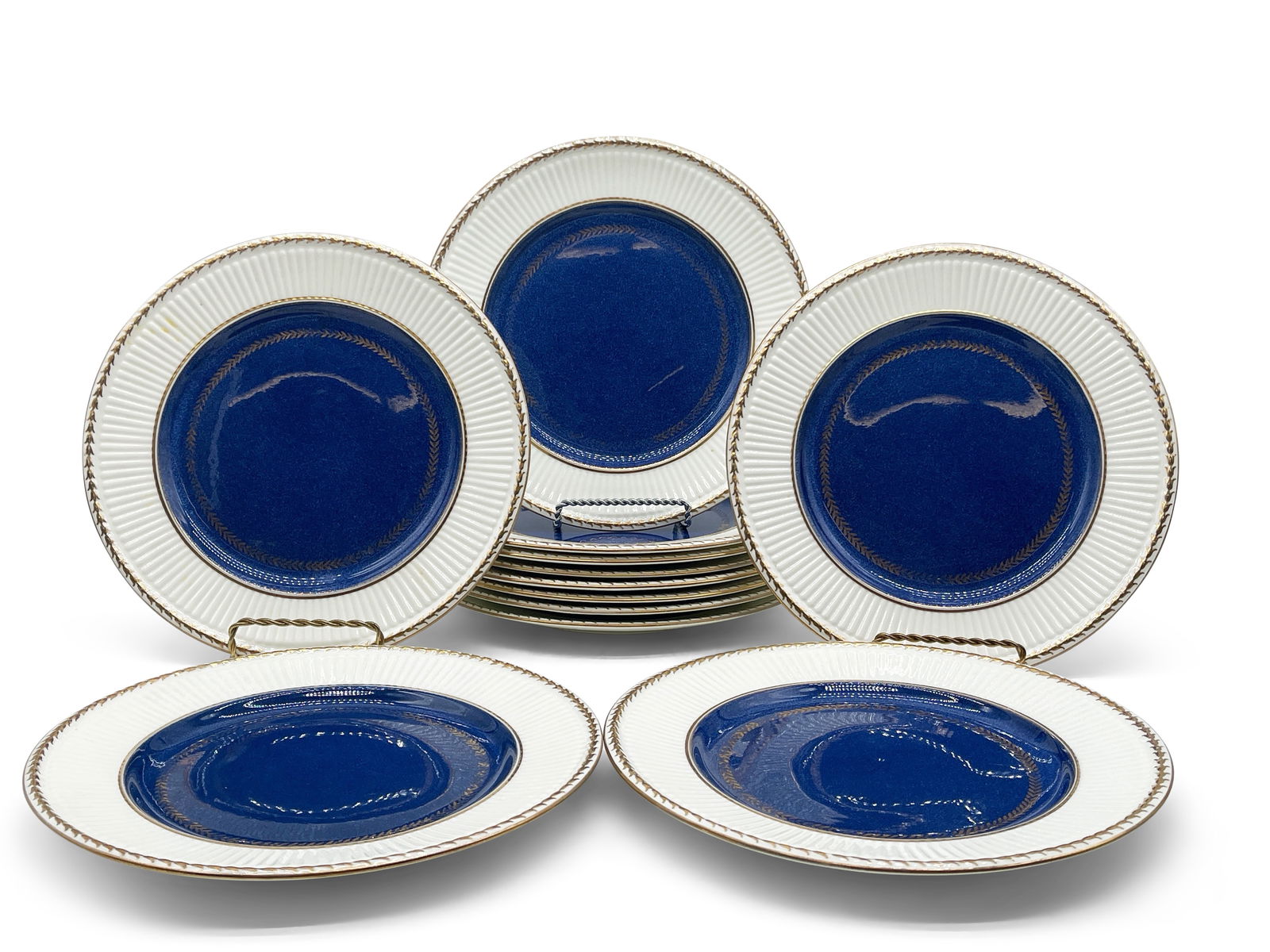 12 Wedgwood Edme Cobalt Plates: A set of 12 Wedgwood Edme porcelain plates with cobalt centers and gilt-decorated edges. Marked on back. 10in diameter. | Philadelphia Metro area delivery, NYC curbside delivery, and international thi