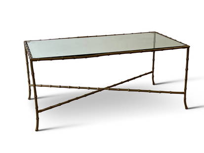 Maison Bagues-style Faux Bamboo Cocktail Table: A Maison Bagues-style faux bamboo brass cocktail coffee table with a rectangular glass top. 18in tall x 41in wide x 21-1/4in deep. | Philadelphia Metro area delivery, NYC curbside delivery, and intern