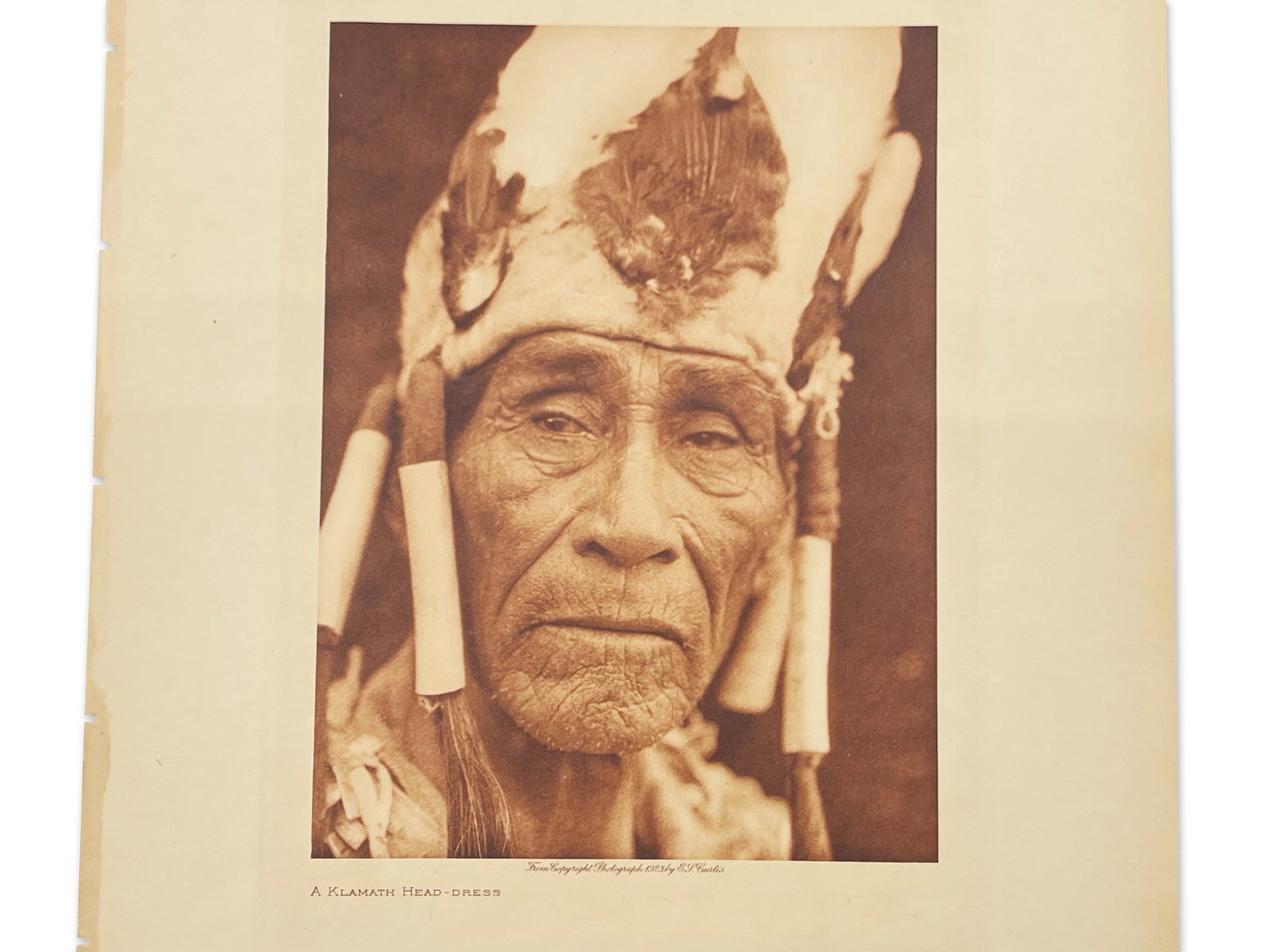 Edward Curtis. Photogravure: Klamath Head Dress: Edward S. Curtis (American 1868-1952). A photogravure titled "A Klamath Head-Dress", 1923. Volume # 13. Japan vellum paper. Sheet: 9in x 12in. | Philadelphia Metro area delivery, NYC curbside delivery