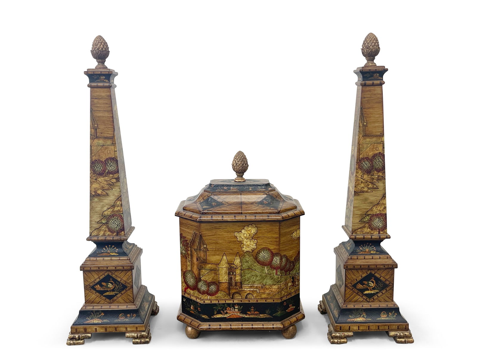 Decorative Arts Inc. Scenic Chest and Obelisks: A decorative chest resting on ball feet with pineapple form finial, scenic motifs, and faux wood inlay, together with a pair of matching obelisks. Obelisks: 26-1/2in tall x 7in wide. | Philadelphia Me