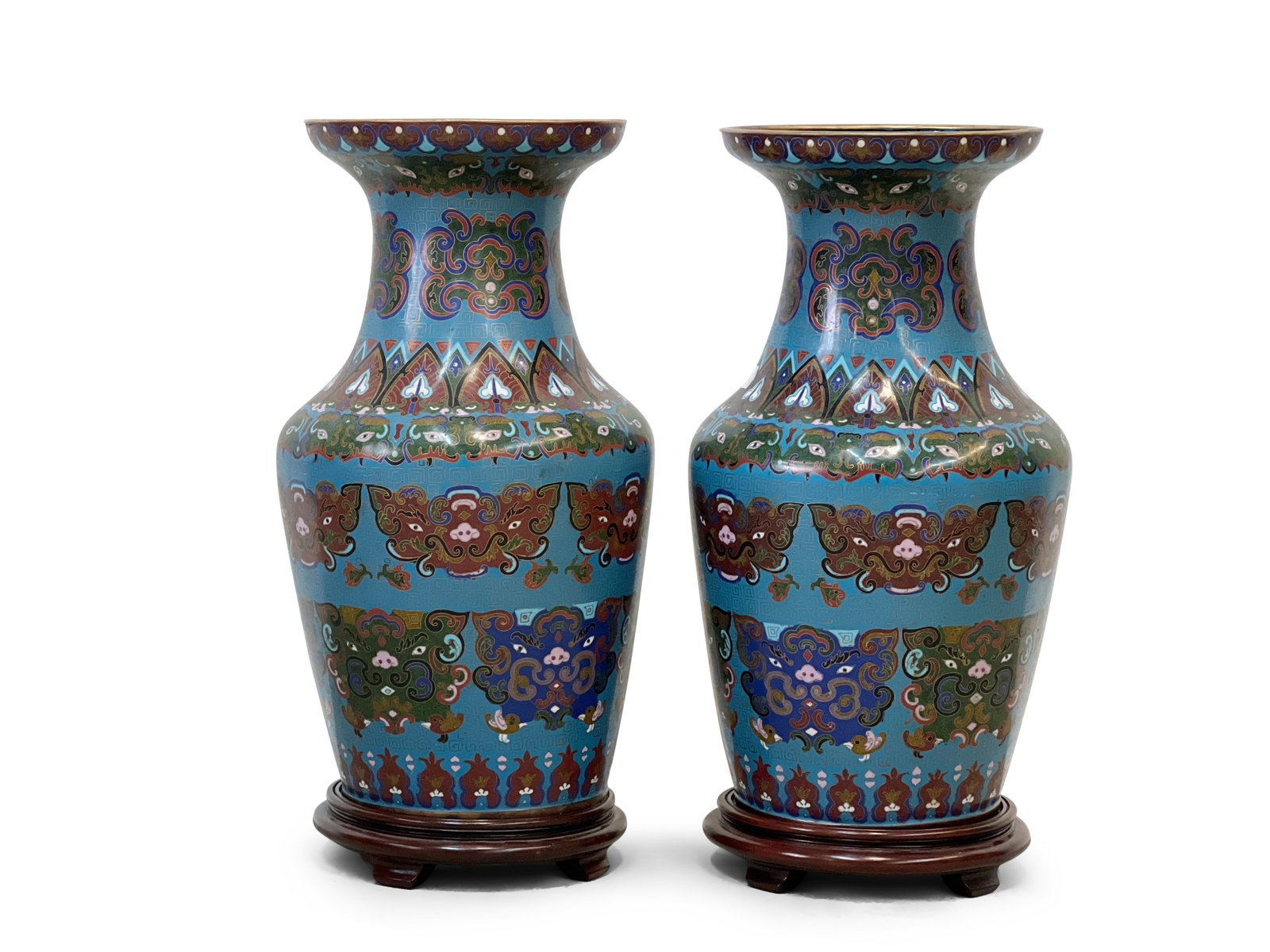 Pair of Chinese Cloisonné Vases: A pair of Chinese cloisonné Vasiform vases, decorated with elaborate taotie masks against a scrolled turquoise ground, and stylized lappets on rim, shoulder, and base, on wood stands. Vases approx. 2