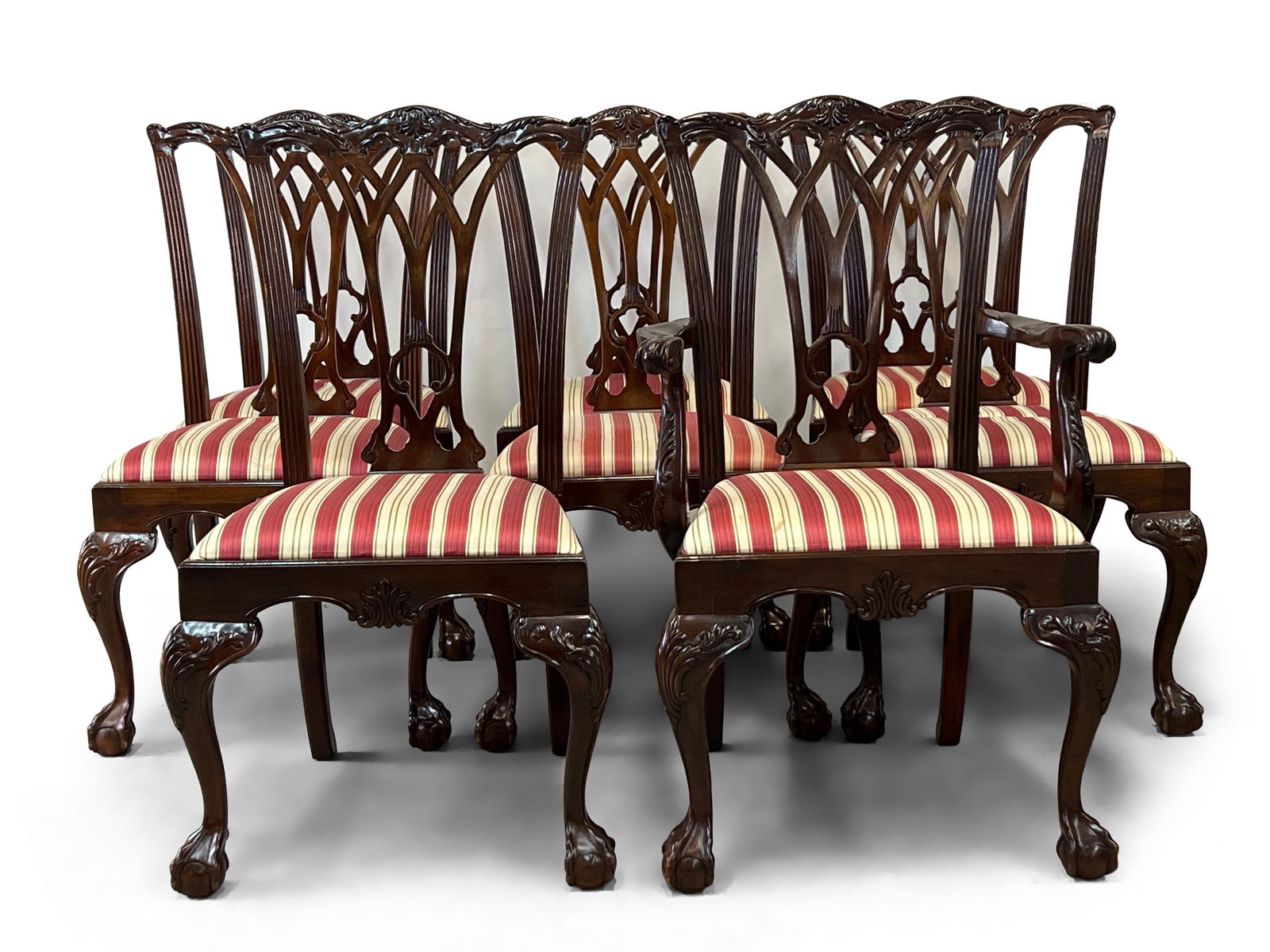 Eight Chippendale-style Mahogany Dining Chairs: A set of eight Chippendale-style mahogany dining chairs with pierced backs, on ball and claw feet. Armchair: 39-1/2in tall x 23-1/2in wide x 18in deep. Seat height: 17-1/2in. | Philadelphia Metro area