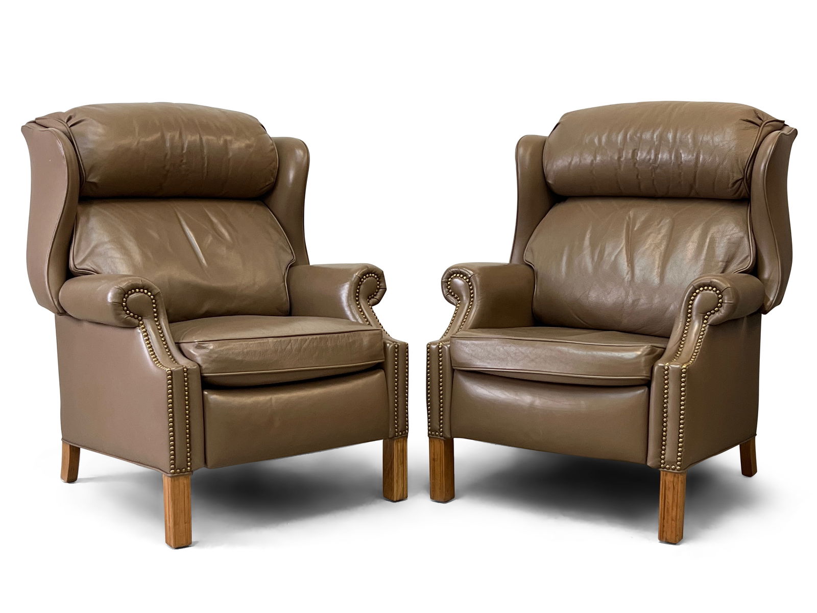 Pair of Hancock & Moore Leather Recliners: A pair of Hancock & Moore leather recliners with brass tacked trim. 40in tall x 33in wide x 33in deep. | Philadelphia Metro area delivery, NYC curbside delivery, and international third-party shipper