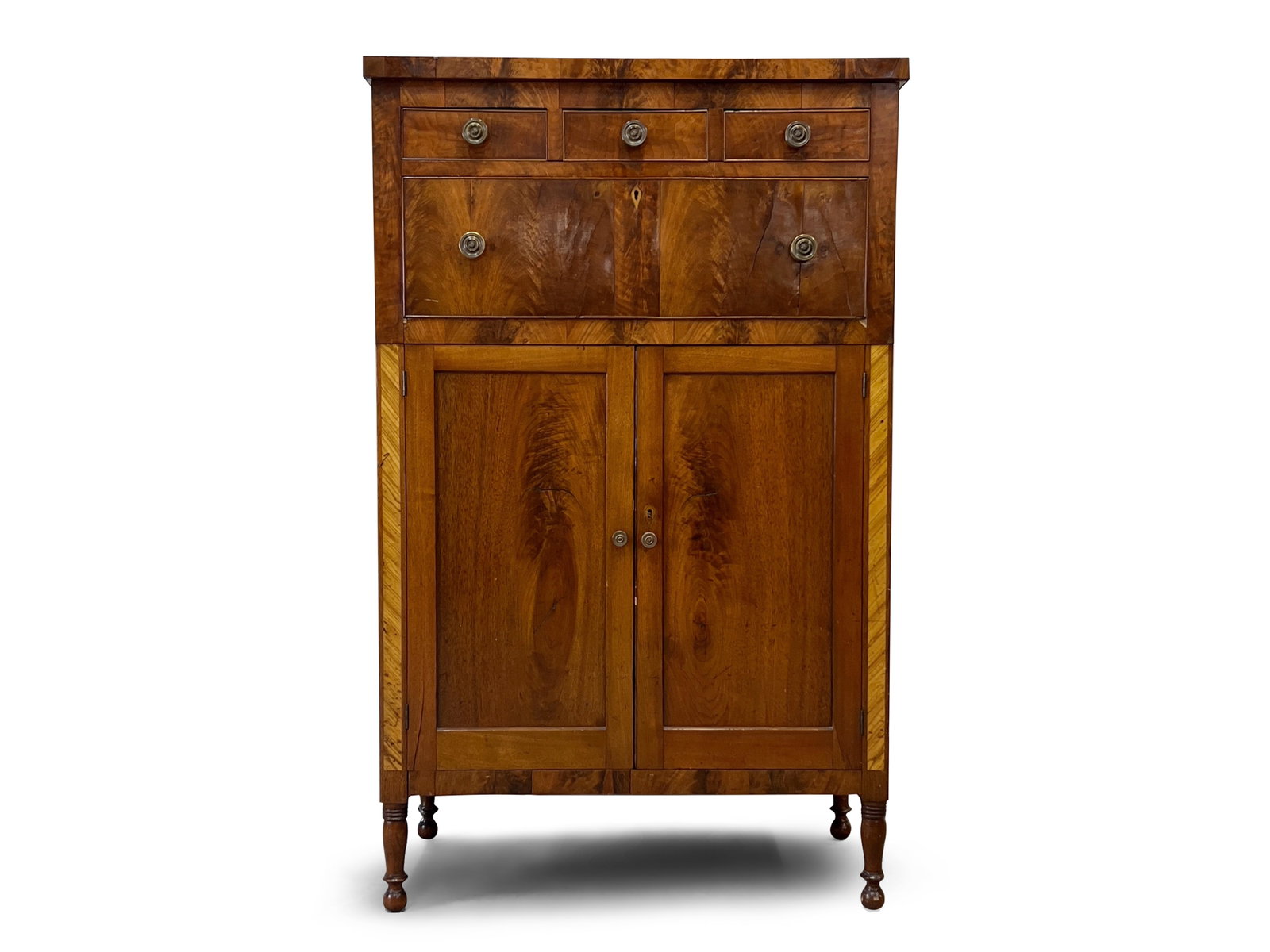 Sheraton Mahogany Cabinet: A Sheraton mahogany cabinet with three shallow over one large drawer and a cupboard base. Raised on turned legs. 59-1/2in tall x 37in wide x 20-1/2in deep. | You have additional shipping options! Phil